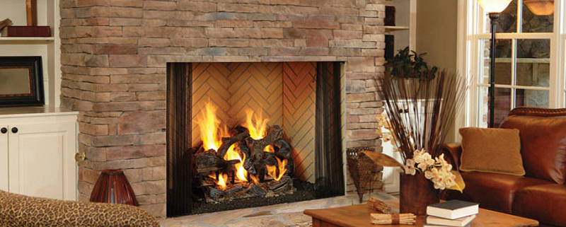 A modern gas fireplace insert installed in a classic living room setting, requiring an annual propane safety check.